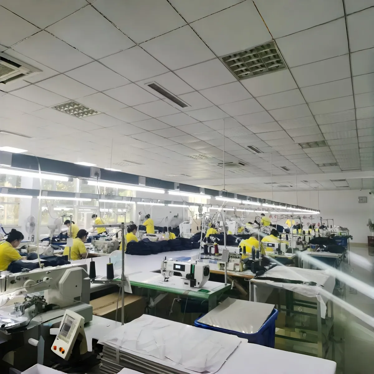 Team members working at sewing machines in the production area