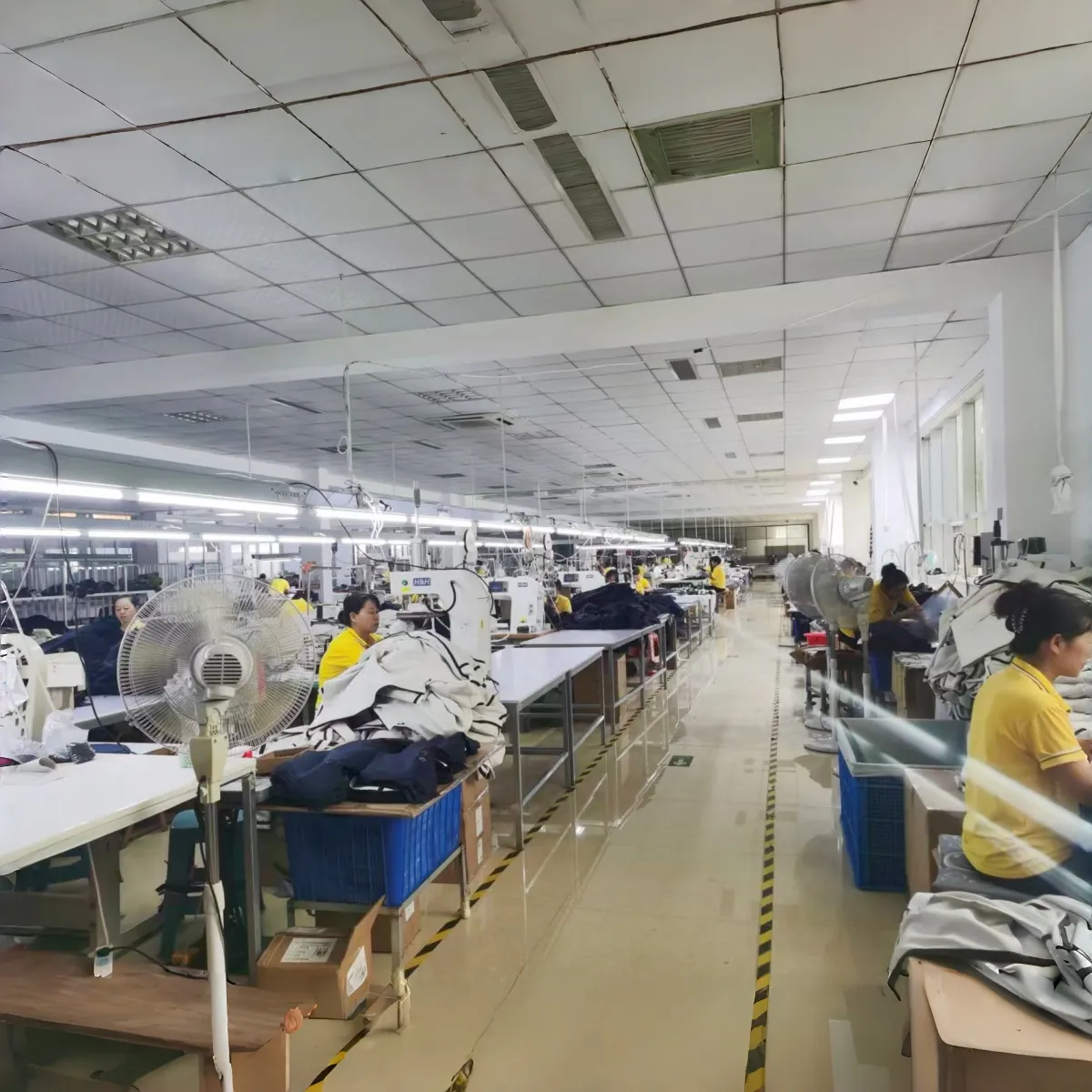 Rows of sewing workstations inside the Yichen Pet workshop